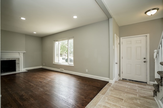17344 Wisconsin St, Detroit, MI 48221 - unfurnished living room with wood finished floors, a fireplace with flush hearth, recessed lighting, and baseboards