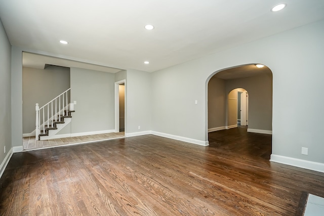 17344 Wisconsin St, Detroit, MI 48221 - unfurnished living room with wood finished floors, recessed lighting, baseboards, stairs, and arched walkways