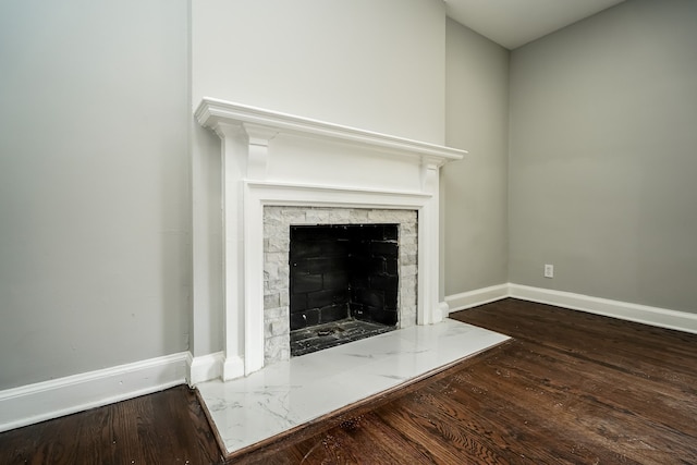 17344 Wisconsin St, Detroit, MI 48221 - detailed view of wood finished floors, baseboards, and a fireplace with flush hearth