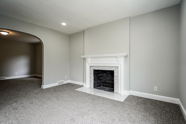 17344 Wisconsin St, Detroit, MI 48221 - unfurnished living room with carpet floors, arched walkways, baseboards, a fireplace with flush hearth, and recessed lighting
