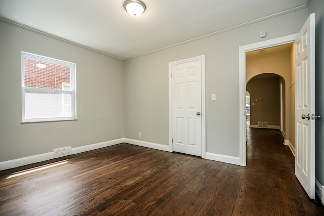 17344 Wisconsin St, Detroit, MI 48221 - spare room featuring arched walkways, dark wood-style floors, plenty of natural light, and crown molding