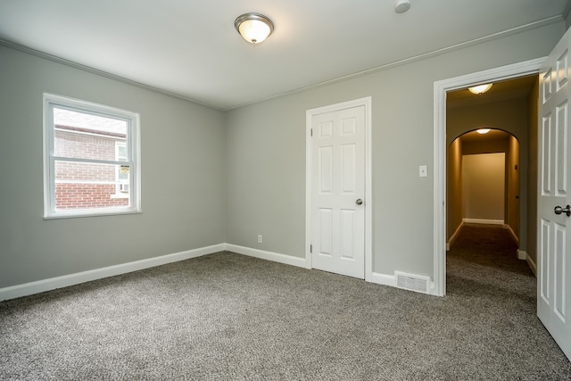 17344 Wisconsin St, Detroit, MI 48221 - unfurnished bedroom with arched walkways, carpet, and baseboards