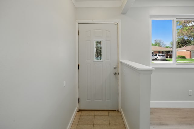 entryway featuring baseboards and light tile patterned floors