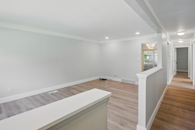 hallway with an upstairs landing, baseboards, light wood-style floors, crown molding, and recessed lighting