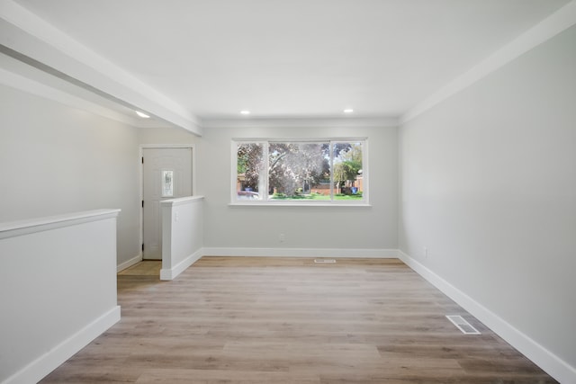 unfurnished room featuring recessed lighting, baseboards, light wood finished floors, and crown molding