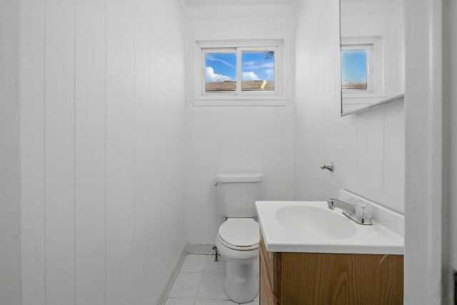 bathroom featuring toilet, marble finish floors, vanity, and baseboards