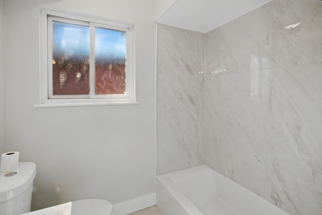 full bath featuring toilet and baseboards