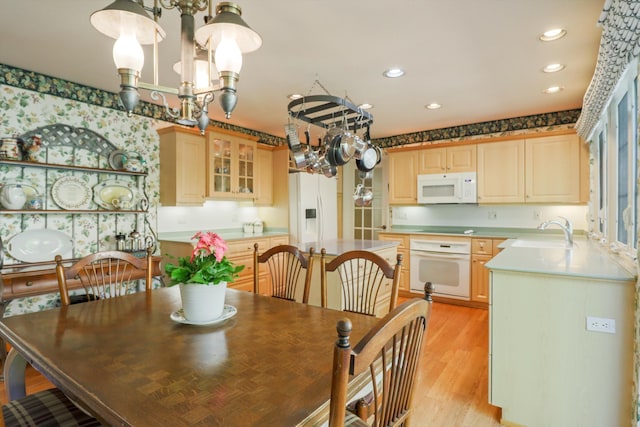 dining area featuring a chandelier, recessed lighting, and light wood finished floors