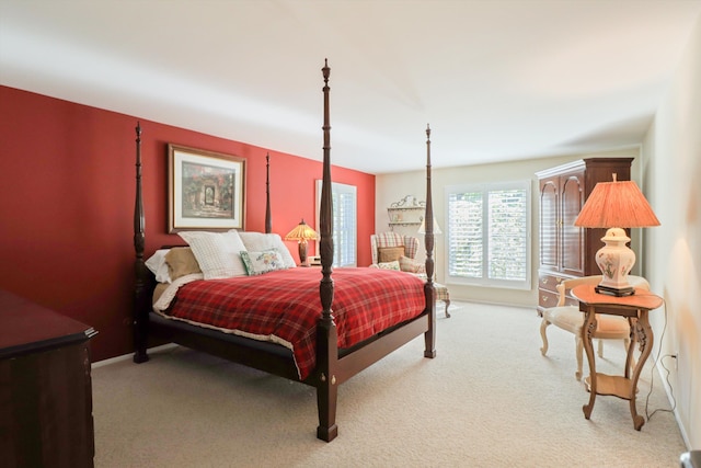 bedroom with light carpet and baseboards