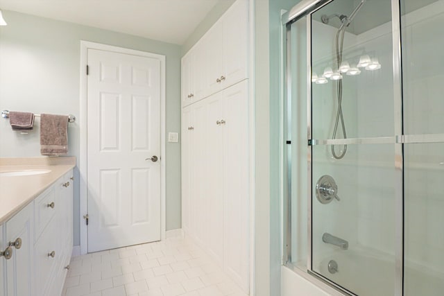full bathroom with tile patterned floors, combined bath / shower with glass door, and vanity