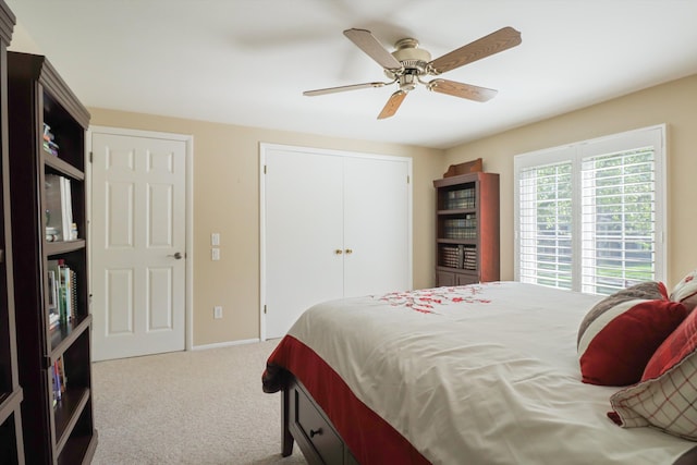 bedroom featuring carpet floors, a closet, ceiling fan, and baseboards