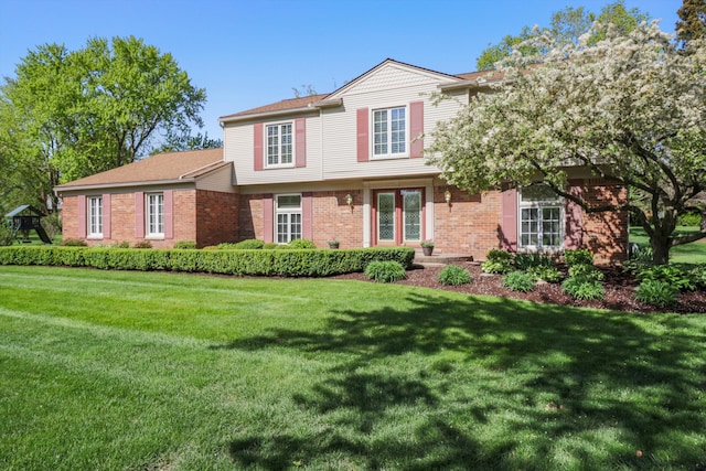 view of front of house featuring brick siding and a front lawn