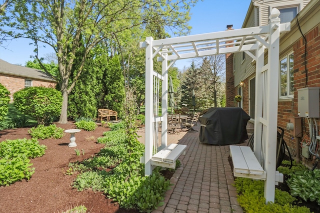view of patio featuring grilling area and a pergola