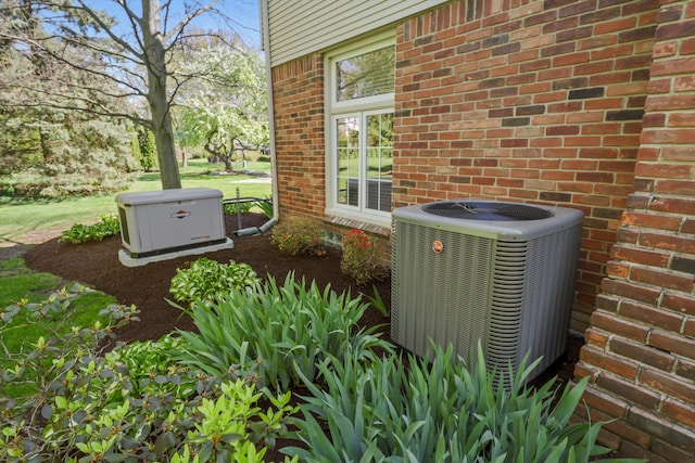 exterior view of central AC unit, brick siding, and a power unit
