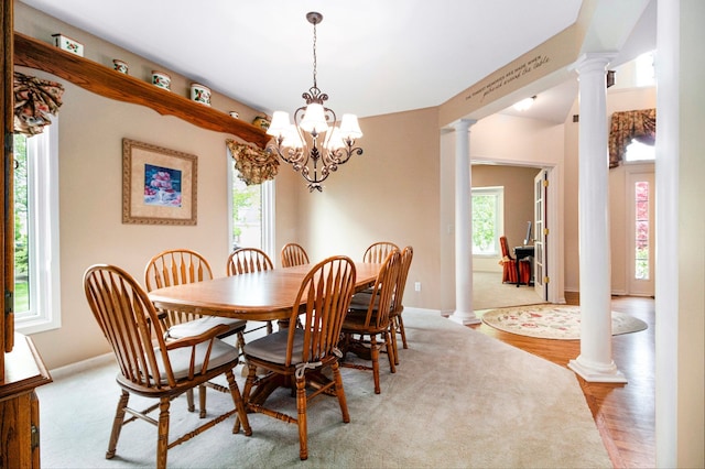 24391 Cavendish Ave E, Novi, MI 48375 - dining area with ornate columns, wood finished floors, a chandelier, and baseboards