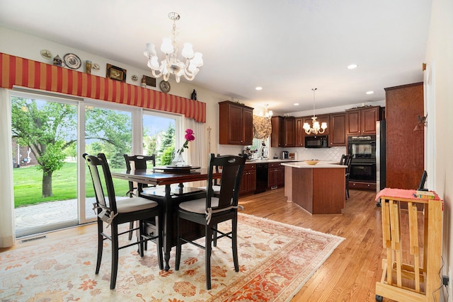 24391 Cavendish Ave E, Novi, MI 48375 - dining area with a chandelier, light wood-style floors, and recessed lighting
