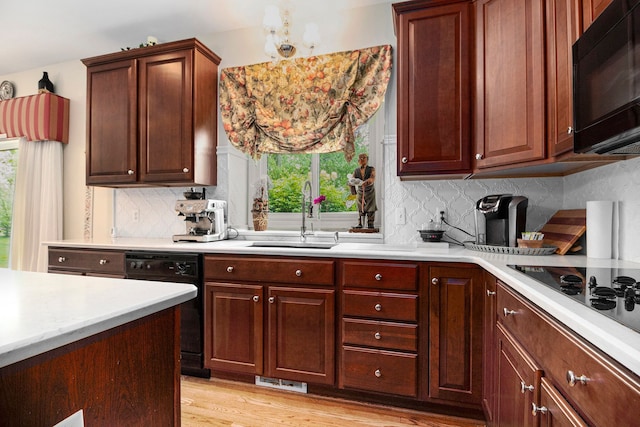 24391 Cavendish Ave E, Novi, MI 48375 - kitchen featuring black appliances, a sink, light countertops, and healthy amount of natural light
