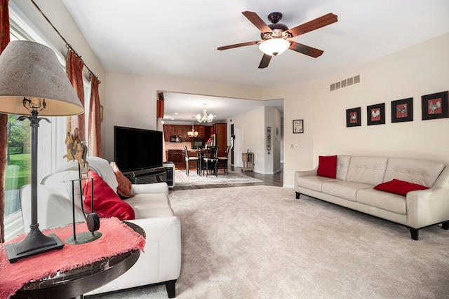 24391 Cavendish Ave E, Novi, MI 48375 - carpeted living room featuring a chandelier, ceiling fan, and baseboards