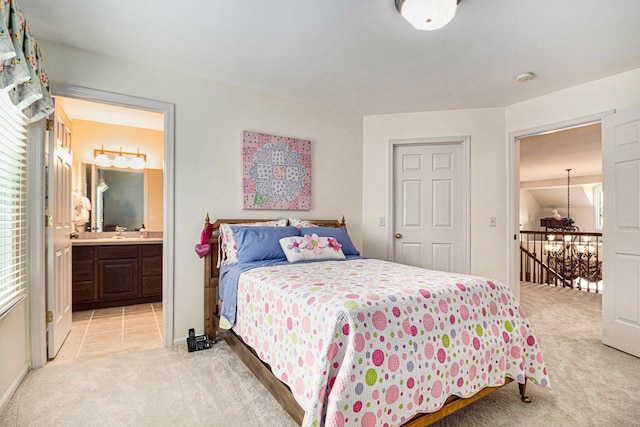 24391 Cavendish Ave E, Novi, MI 48375 - bedroom with light carpet, ensuite bath, and baseboards