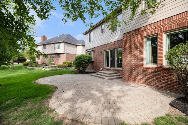 24391 Cavendish Ave E, Novi, MI 48375 - rear view of property featuring brick siding, a yard, and a patio