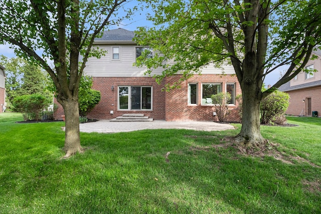 24391 Cavendish Ave E, Novi, MI 48375 - back of house with a patio area, brick siding, and a lawn