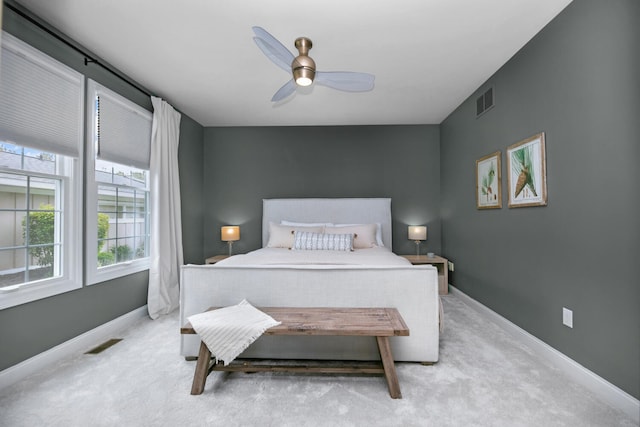 carpeted bedroom featuring baseboards and a ceiling fan