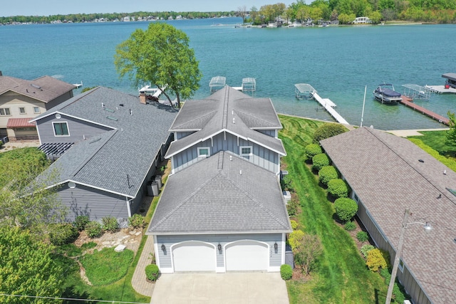 aerial view of property and surrounding area with a large body of water