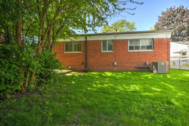 11837 Meteor Dr, Sterling Heights, MI 48313 - view of property exterior featuring brick siding and central AC unit