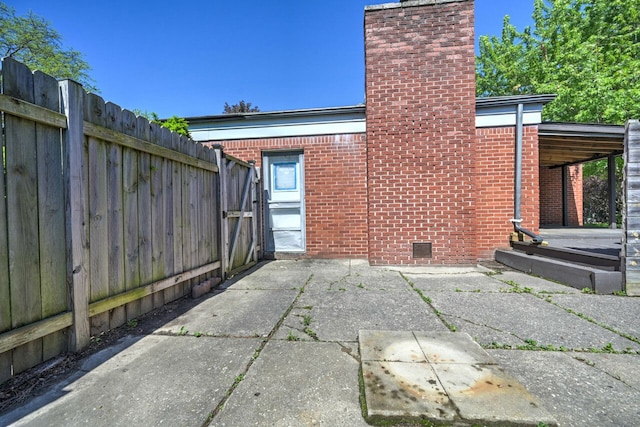 11837 Meteor Dr, Sterling Heights, MI 48313 - rear view of property featuring a chimney, brick siding, fence, crawl space, and a patio