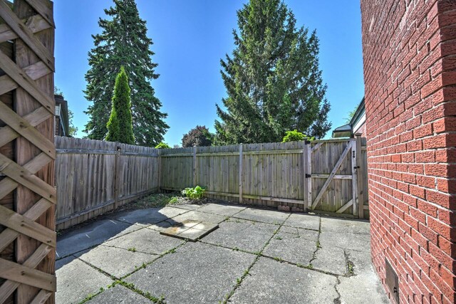 11837 Meteor Dr, Sterling Heights, MI 48313 - view of patio featuring a gate and a fenced backyard