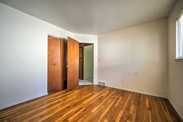 11837 Meteor Dr, Sterling Heights, MI 48313 - unfurnished bedroom with wood finished floors, baseboards, and a closet