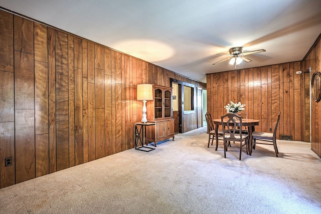 11837 Meteor Dr, Sterling Heights, MI 48313 - carpeted dining area with ceiling fan and wood walls