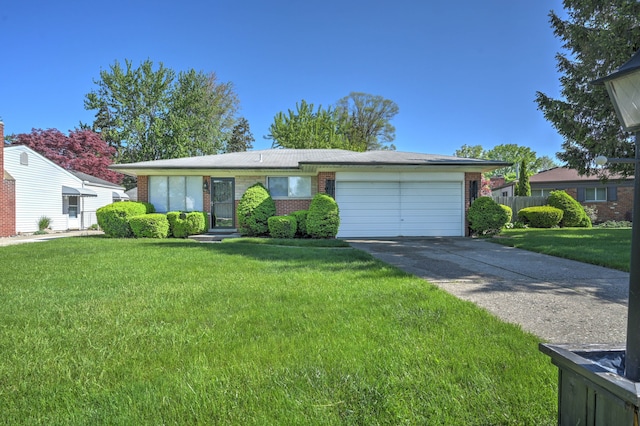 11837 Meteor Dr, Sterling Heights, MI 48313 - ranch-style house featuring a garage, brick siding, and driveway