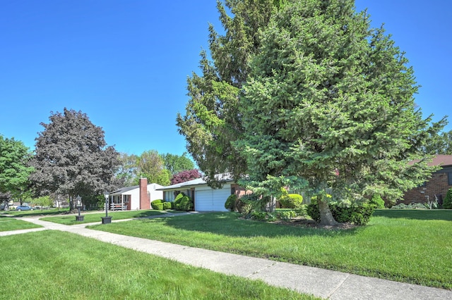 11837 Meteor Dr, Sterling Heights, MI 48313 - view of front of home with an attached garage and a front lawn