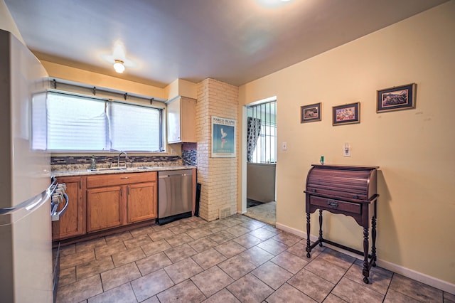 11837 Meteor Dr, Sterling Heights, MI 48313 - kitchen featuring dishwasher, brown cabinets, a sink, freestanding refrigerator, and light tile patterned floors