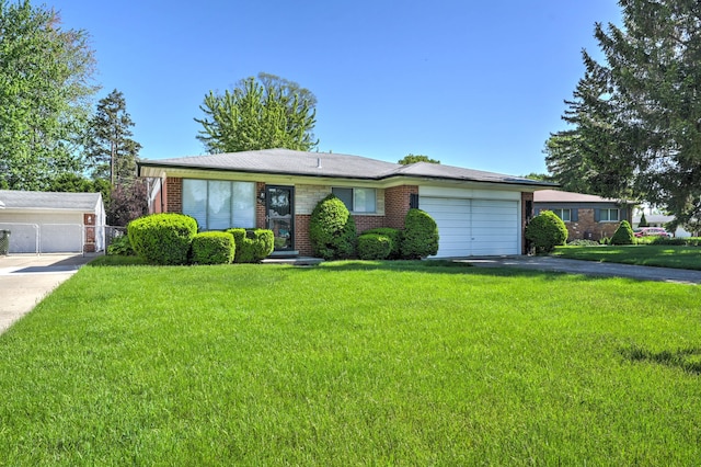 11837 Meteor Dr, Sterling Heights, MI 48313 - view of front of property with brick siding, an attached garage, a front lawn, and driveway