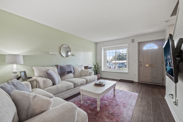 living area featuring dark wood-type flooring and baseboards