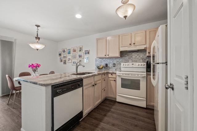 kitchen with white appliances, a peninsula, dark wood-style flooring, under cabinet range hood, and recessed lighting