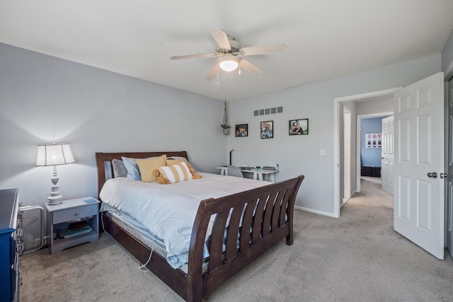 bedroom featuring light carpet, a ceiling fan, and baseboards