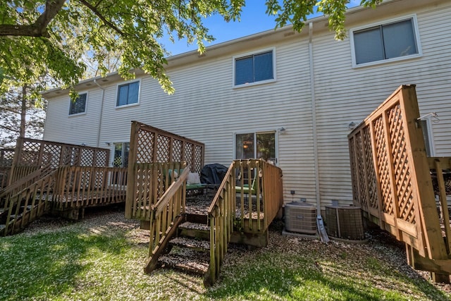 rear view of property with central AC, a deck, and stairs