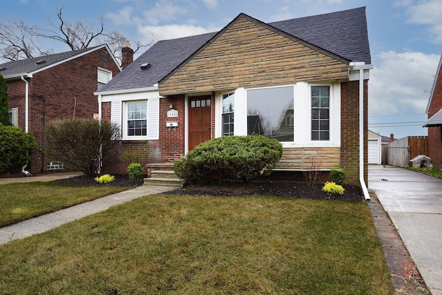 view of front of home with a front lawn, a shingled roof, brick siding, and a chimney