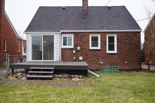 rear view of house featuring roof with shingles, a chimney, a deck, and brick siding