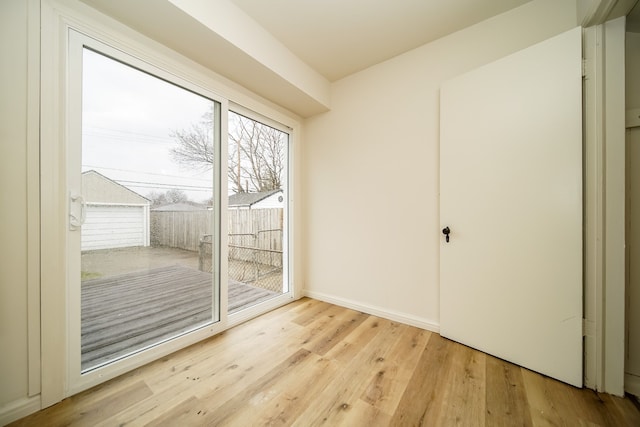 entryway with light wood-type flooring and baseboards