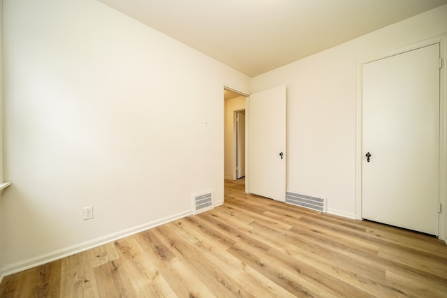 unfurnished bedroom featuring light wood finished floors and baseboards