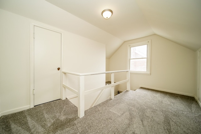 bonus room featuring carpet flooring, lofted ceiling, and baseboards