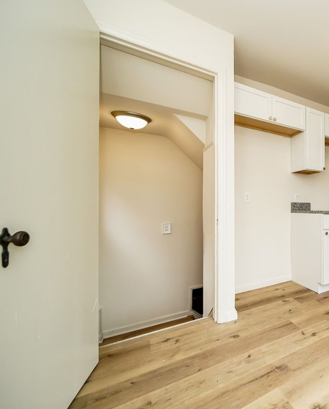 laundry area featuring light wood-style floors