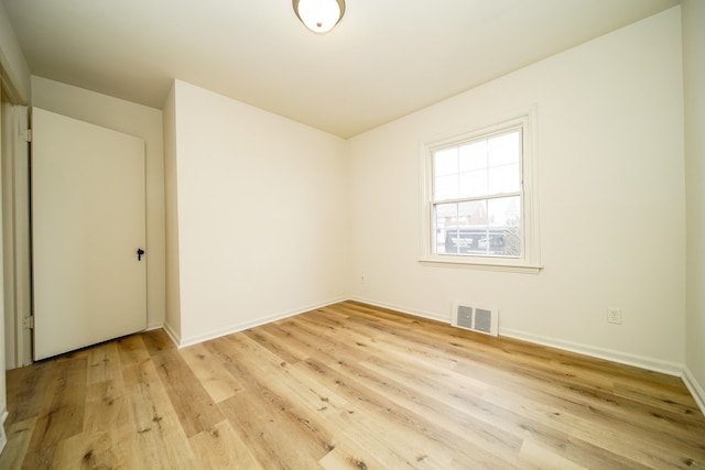 unfurnished room with light wood finished floors and baseboards