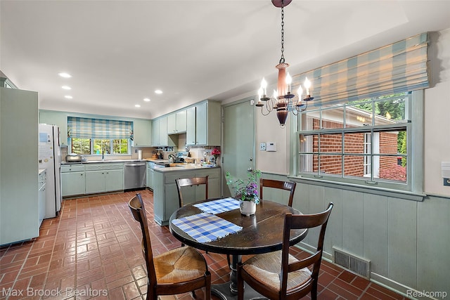 3287 Bradway Blvd, Bloomfield Hills, MI 48301 - dining area with a chandelier, brick patterned floors, recessed lighting, and a wainscoted wall