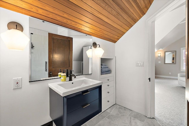 bathroom featuring vaulted ceiling, baseboards, and vanity
