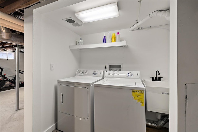 washroom featuring separate washer and dryer and a sink